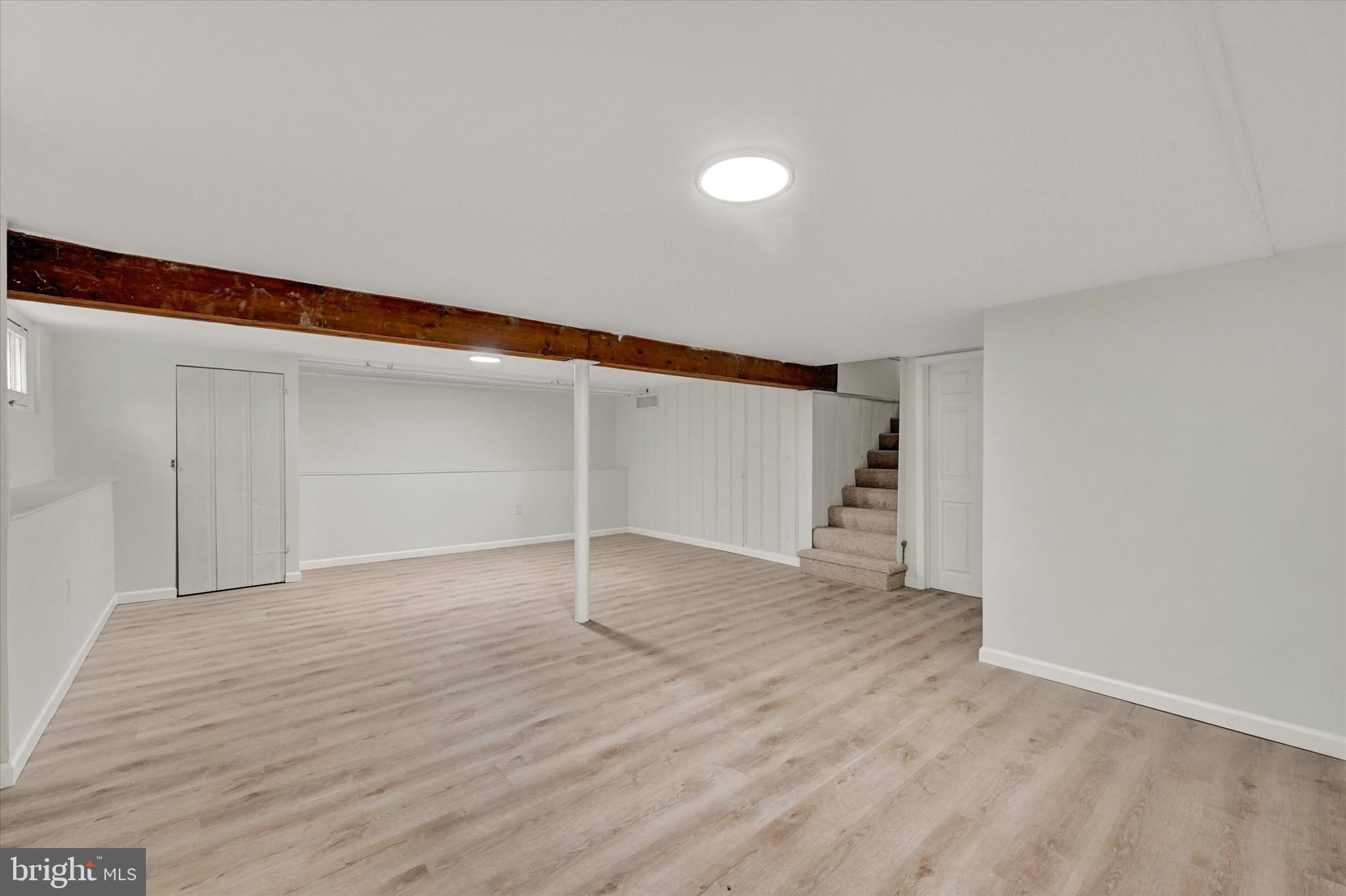 1032 Elm Ridge Avenue Baltimore, MD 21229 - Photo 21 of 28 a view of an empty room with wooden floor