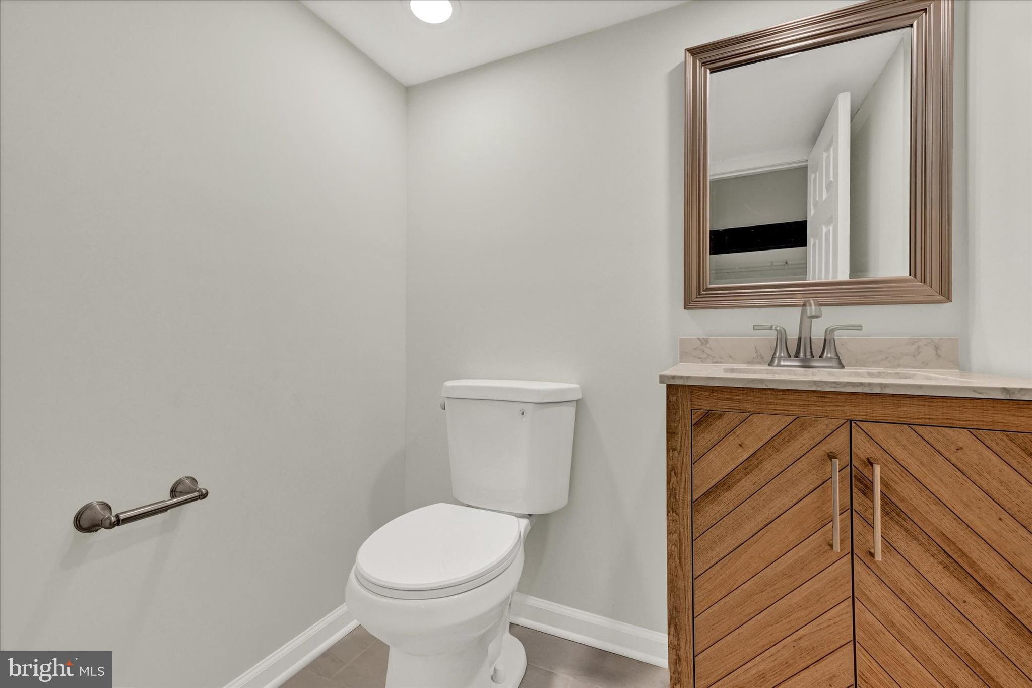 1032 Elm Ridge Avenue Baltimore, MD 21229 - Photo 22 of 28 a bathroom with a sink vanity and toilet