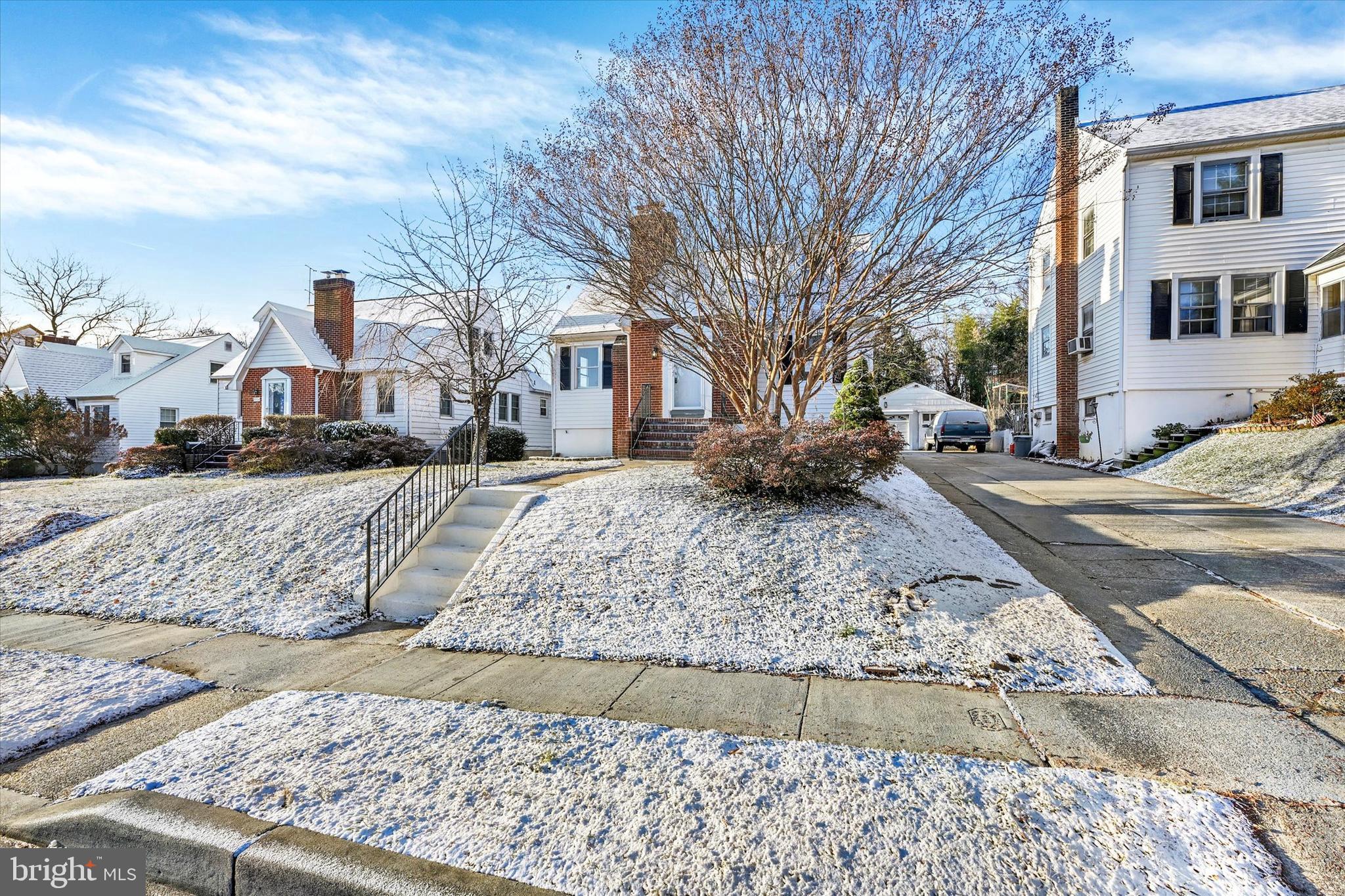 1032 Elm Ridge Avenue Baltimore, MD 21229 - Photo 28 of 28 a view of a white house with a yard covered in snow
