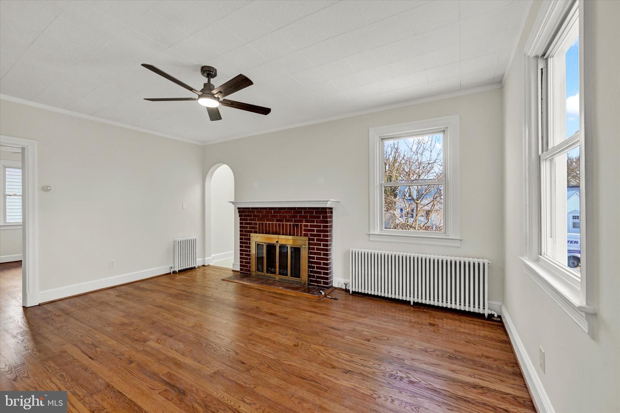 1032 Elm Ridge Avenue Baltimore, MD 21229 - Photo 6 of 28 wooden floor in an empty room with a window