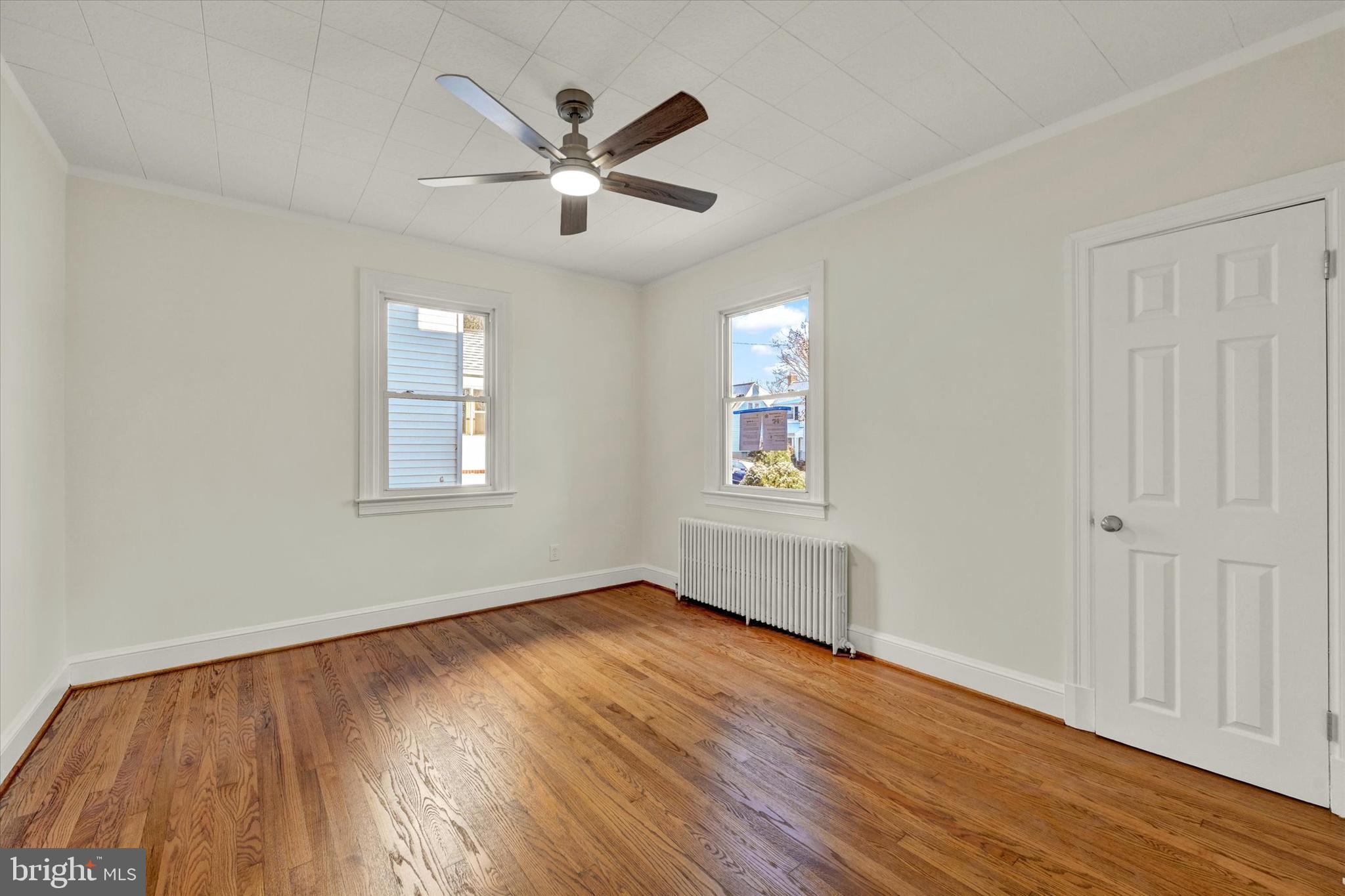 1032 Elm Ridge Avenue Baltimore, MD 21229 - Photo 8 of 28 a view of empty room with wooden floor and fan