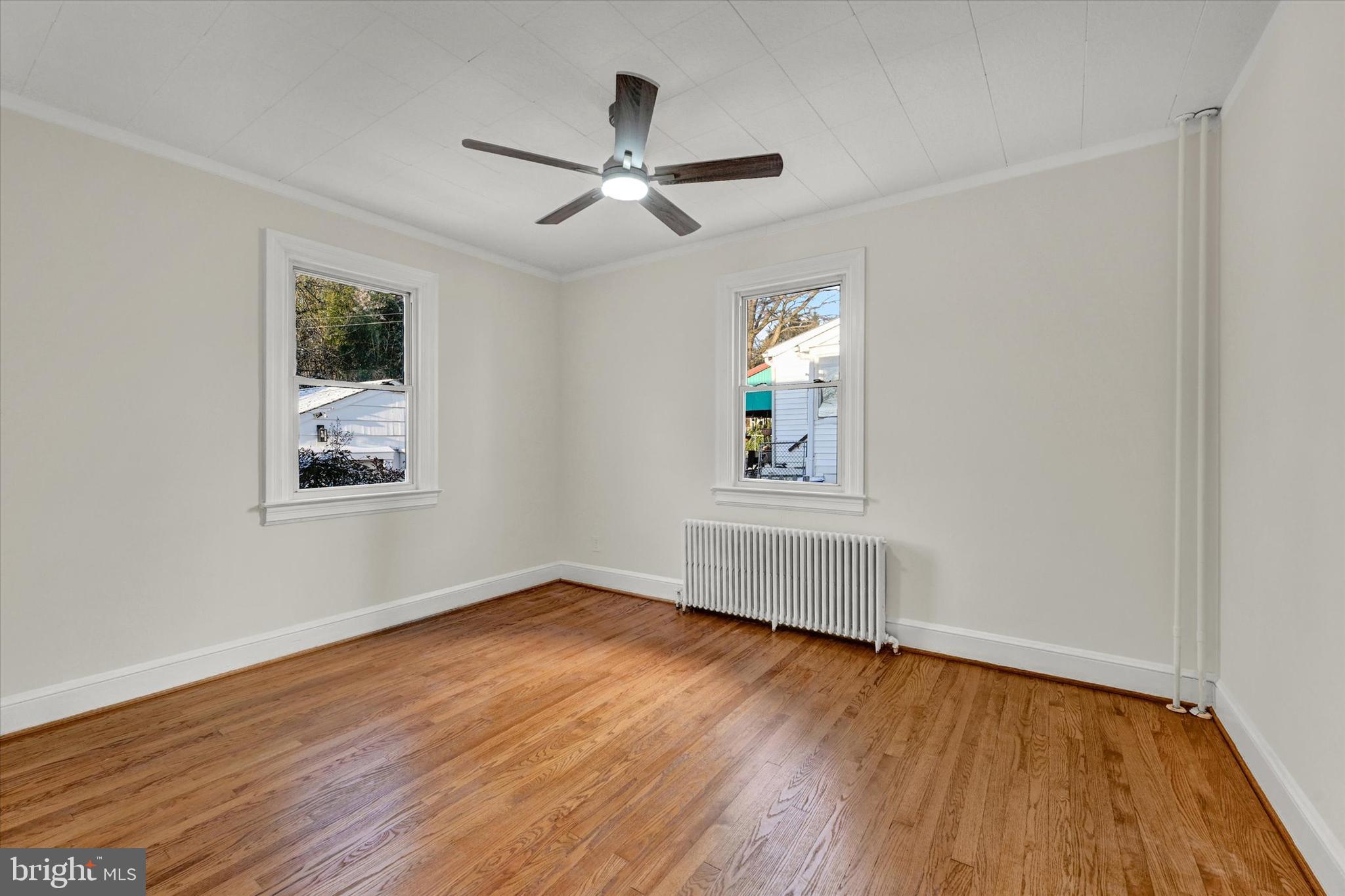 1032 Elm Ridge Avenue Baltimore, MD 21229 - Photo 10 of 28 a view of an empty room with wooden floor and a window