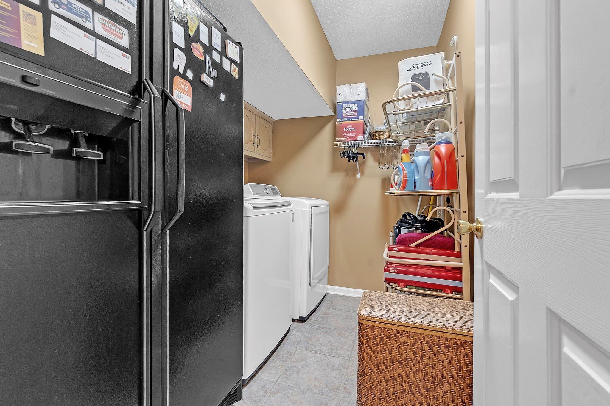 4020 Altruria Road Bartlett, TN 38135 - Photo 11 of 25 Dedicated laundry area featuring a white washing machine, white clothes dryer, and overhead wall cabinetry