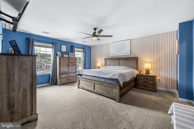 a bedroom with a large bed and a chandelier