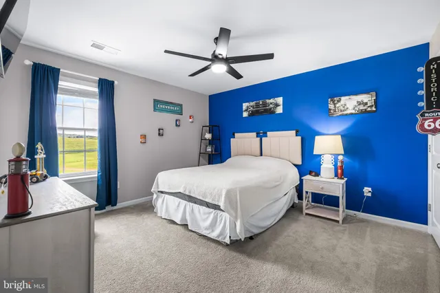 a spacious bedroom with a bed and a chandelier