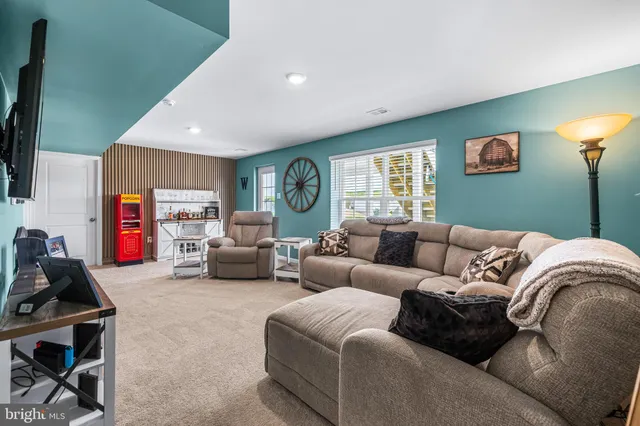 a living room with furniture gym equipment and a window