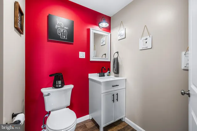 a bathroom with a toilet sink and mirror