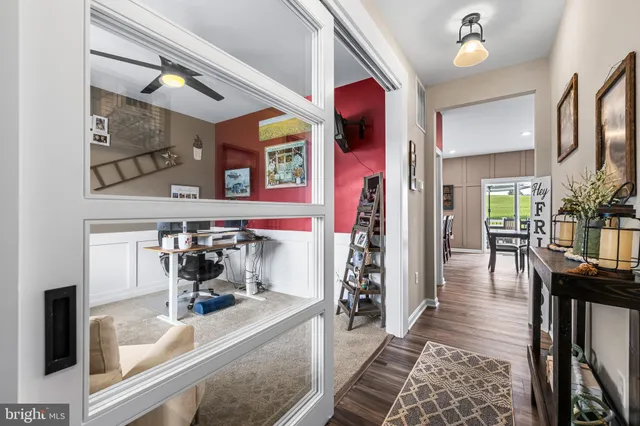 a hallway with dining table and chairs