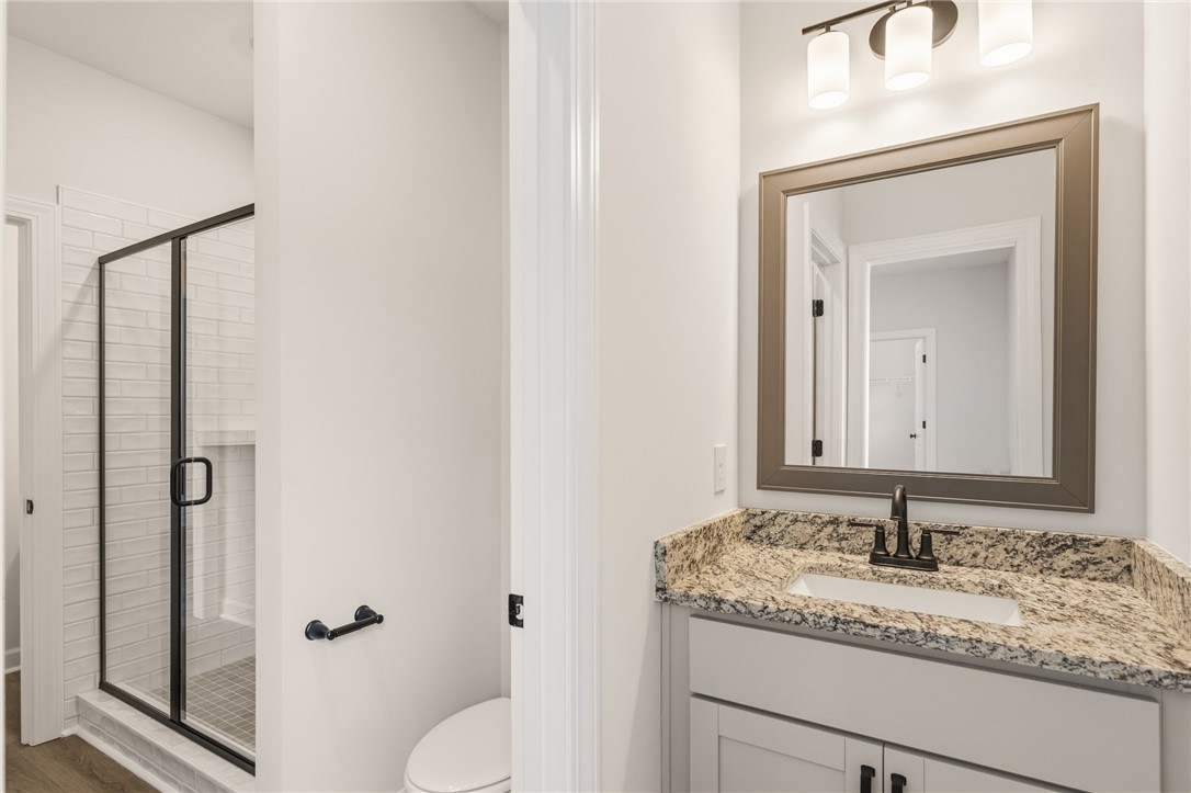 705 Weathered Oak Way Anderson, SC 29621 - Photo 42 of 47 This clean bathroom showcases a sleek vanity with ample storage and a modern shower.