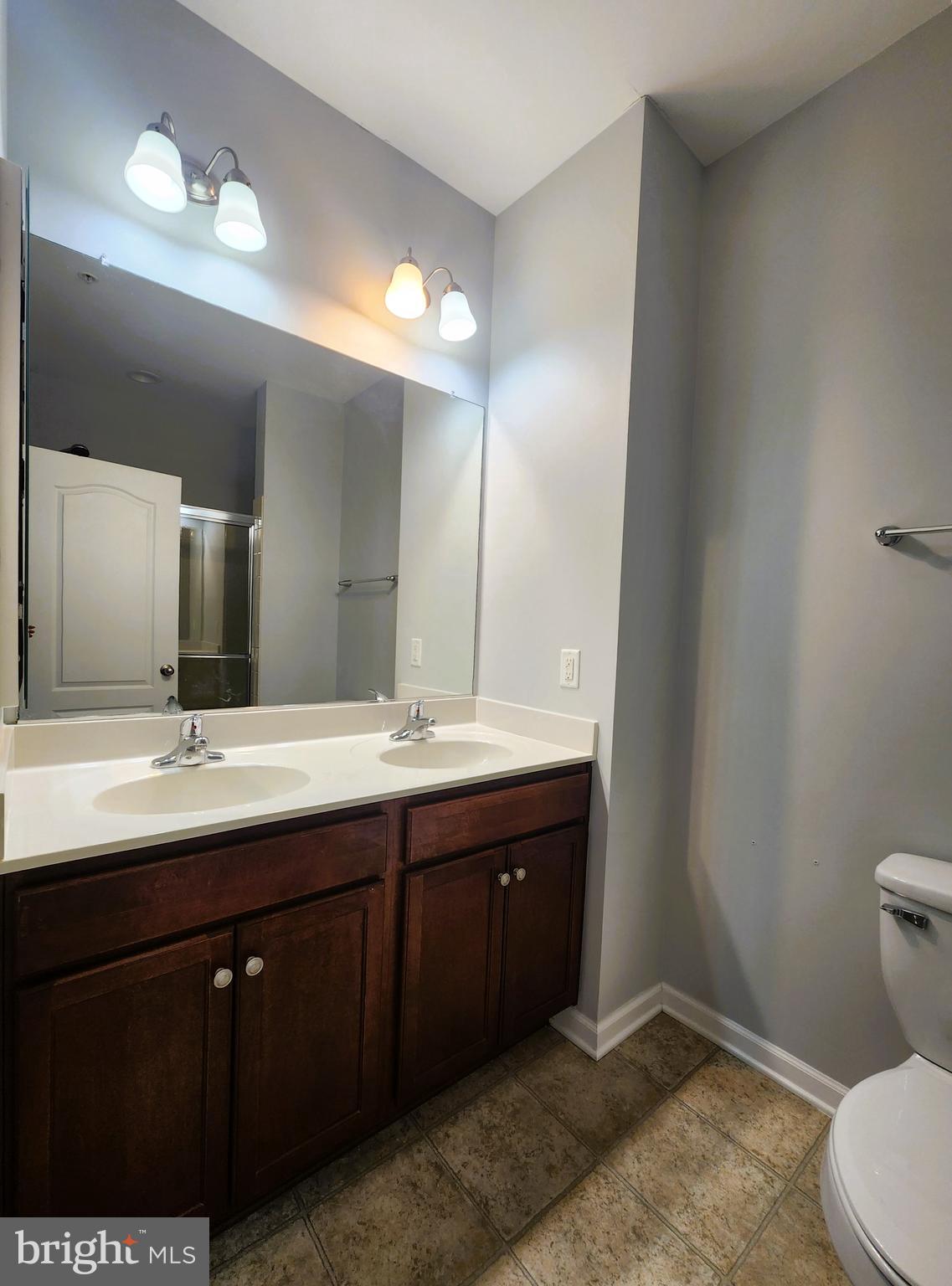 102 Mill Pond Road Frederick, MD 21701 - Photo 19 of 29 a bathroom with a double vanity sink a toilet and a mirror