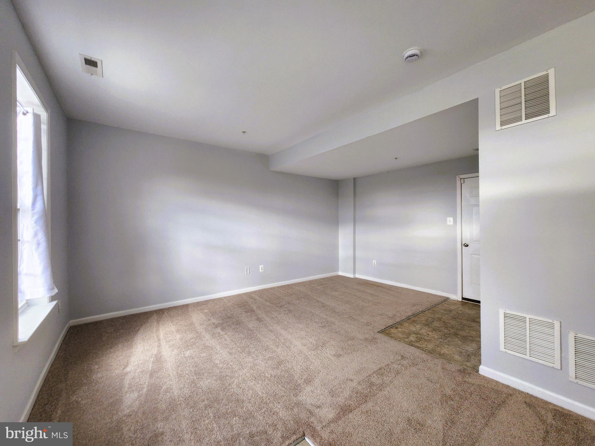 102 Mill Pond Road Frederick, MD 21701 - Photo 3 of 29 an empty room with wooden floor and windows