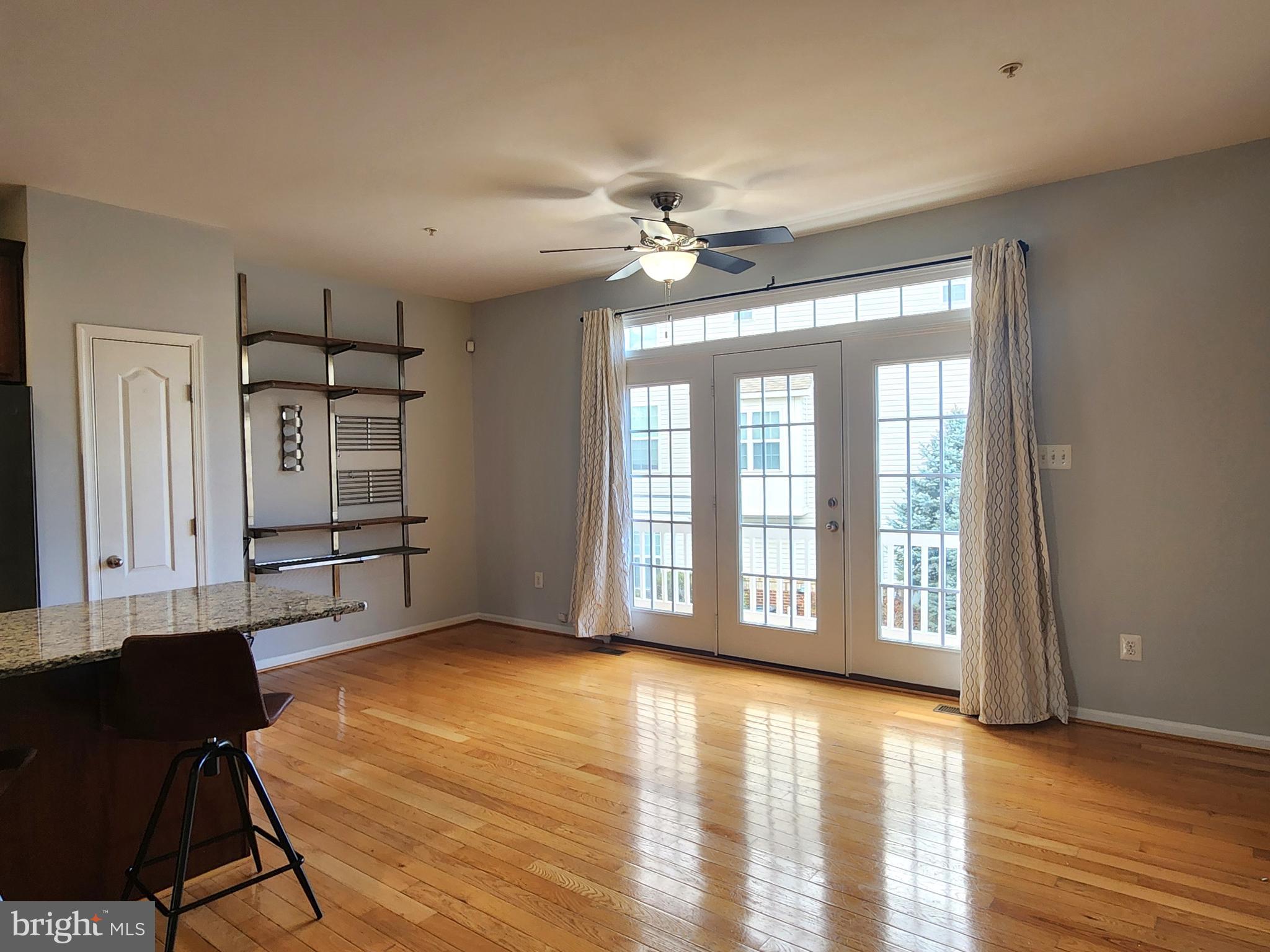 102 Mill Pond Road Frederick, MD 21701 - Photo 5 of 29 a view of an empty room with window and wooden floor