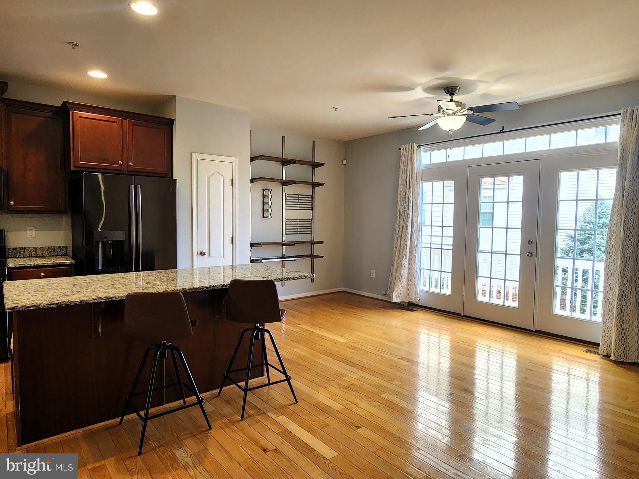 102 Mill Pond Road Frederick, MD 21701 - Photo 7 of 29 a view of an empty room with kitchen and a window