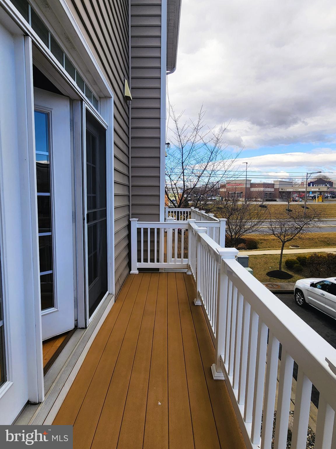 102 Mill Pond Road Frederick, MD 21701 - Photo 10 of 29 a view of balcony with couch and wooden floor
