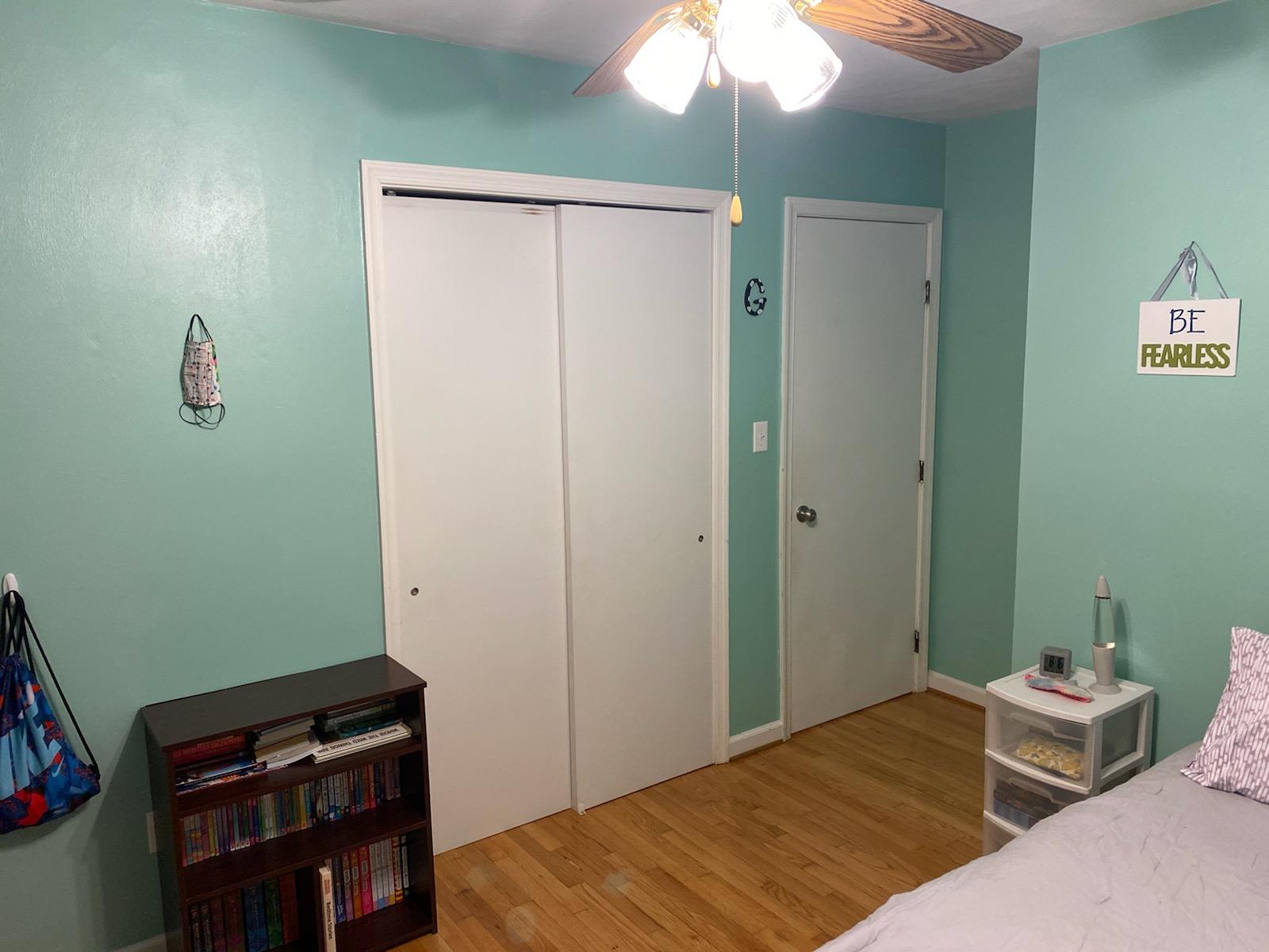 601 Olney Road Vinton, VA 24179 - Photo 13 of 18 a bedroom with a bed and a chandelier