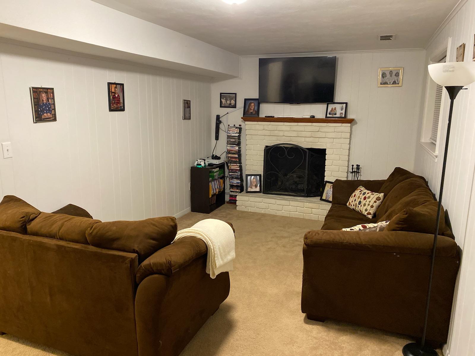 601 Olney Road Vinton, VA 24179 - Photo 16 of 18 a living room with furniture a flat screen tv and a fireplace