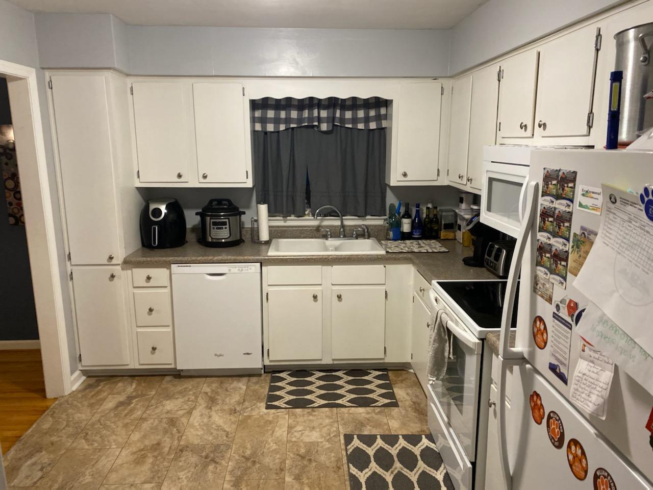 601 Olney Road Vinton, VA 24179 - Photo 5 of 18 a kitchen with white cabinets sink and stove