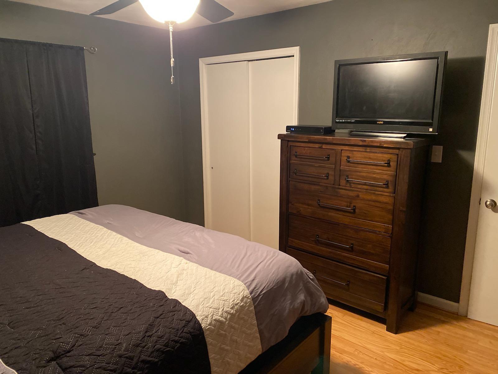 601 Olney Road Vinton, VA 24179 - Photo 8 of 18 a bedroom with a bed and a flat tv screen on dresser