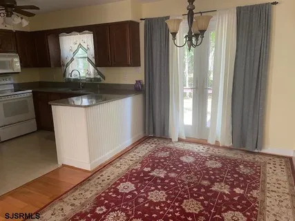 a kitchen with a refrigerator sink and cabinets