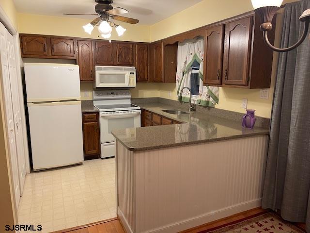 1431 Stagecoach Road Ocean View, NJ 08230 - Photo 6 of 11 a kitchen with a refrigerator sink and cabinets