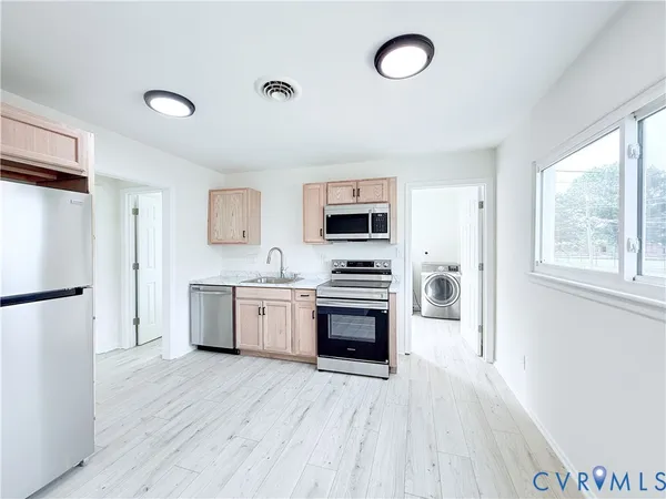 a kitchen with a refrigerator stove and sink