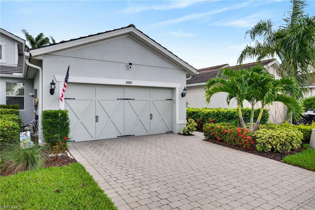 20105 Torch Key Way Estero, FL 33928 - Photo 2 of 29 a view of a house with a yard and plants