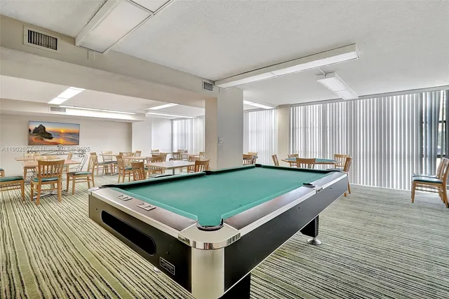 a view of swimming pool with outdoor seating and plants