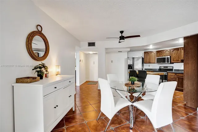 a view of a dining room with furniture and a chandelier