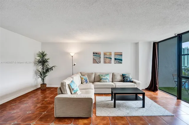 a living room with furniture and a potted plant