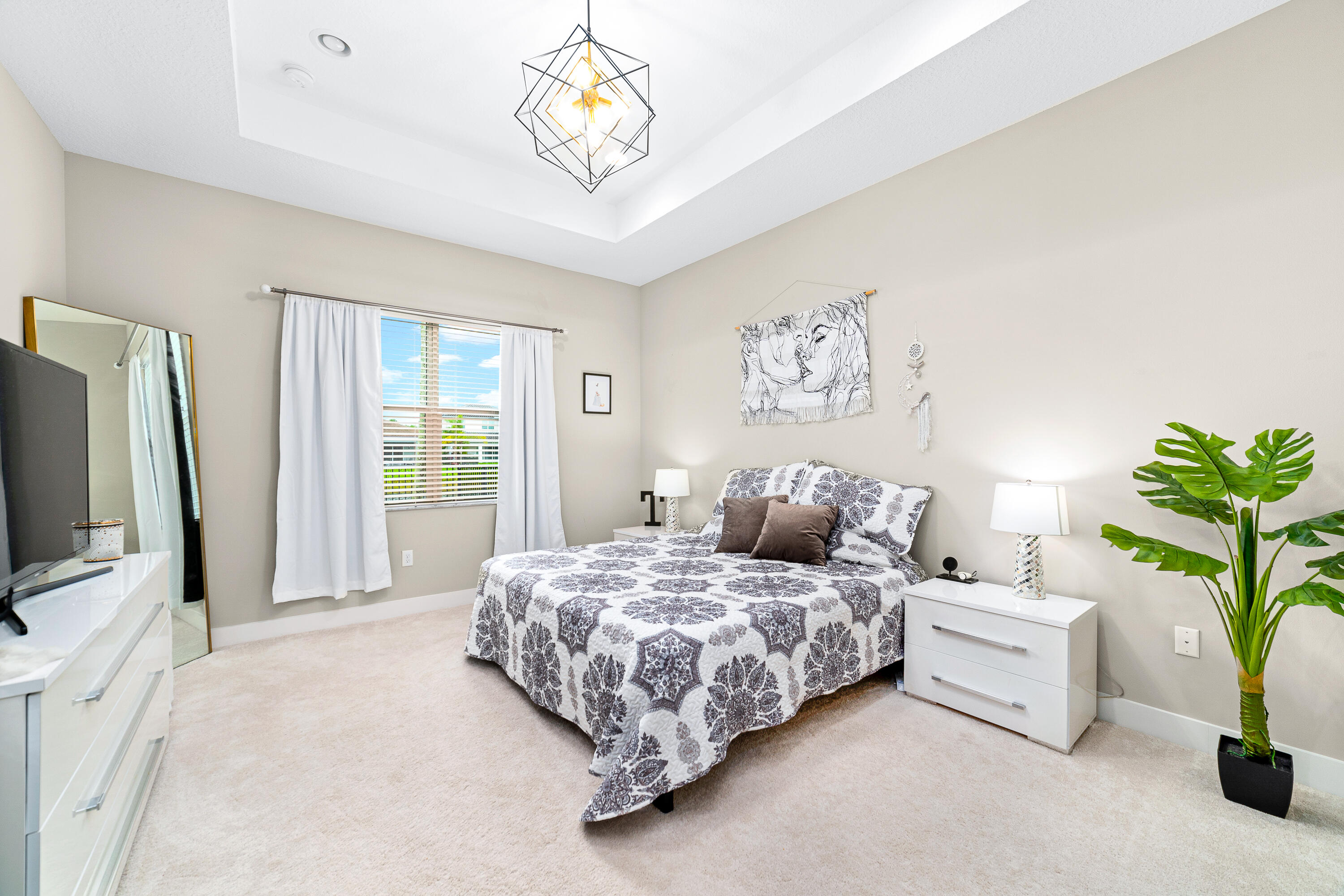 15380 Blue River Road Delray Beach, FL 33446 - Photo 12 of 31 a bedroom with bed and a flat tv screen on dresser