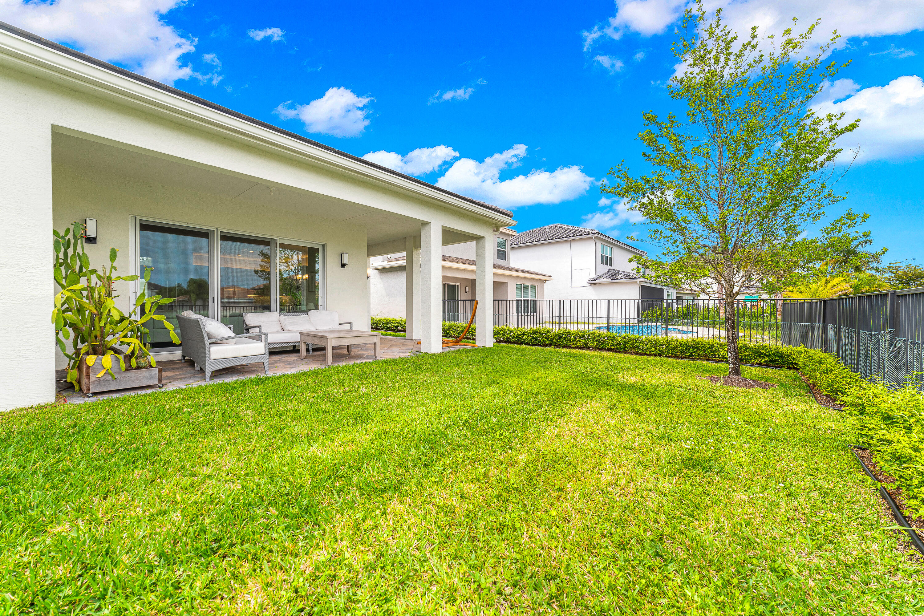 15380 Blue River Road Delray Beach, FL 33446 - Photo 24 of 31 a view of a house with backyard and porch