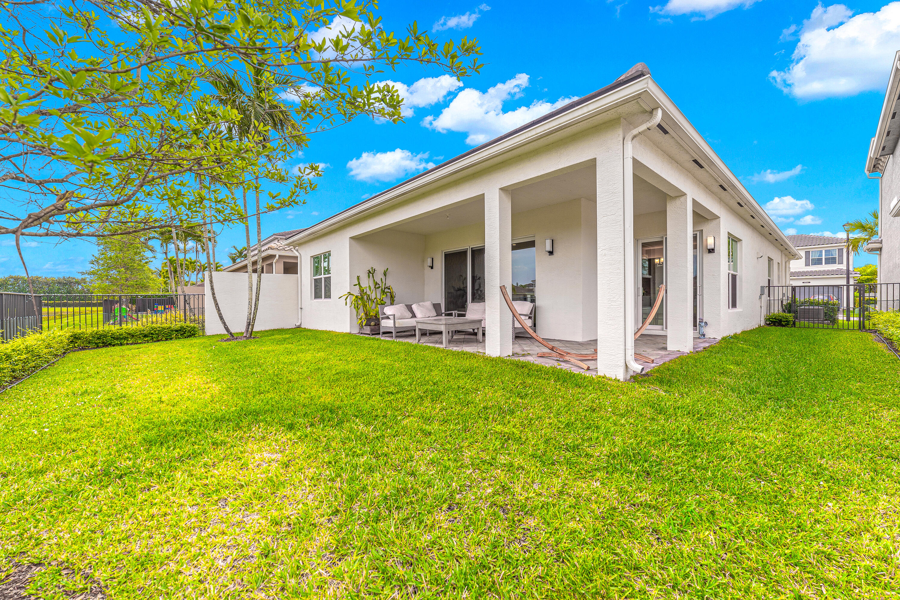 15380 Blue River Road Delray Beach, FL 33446 - Photo 25 of 31 a view of a house with backyard and porch