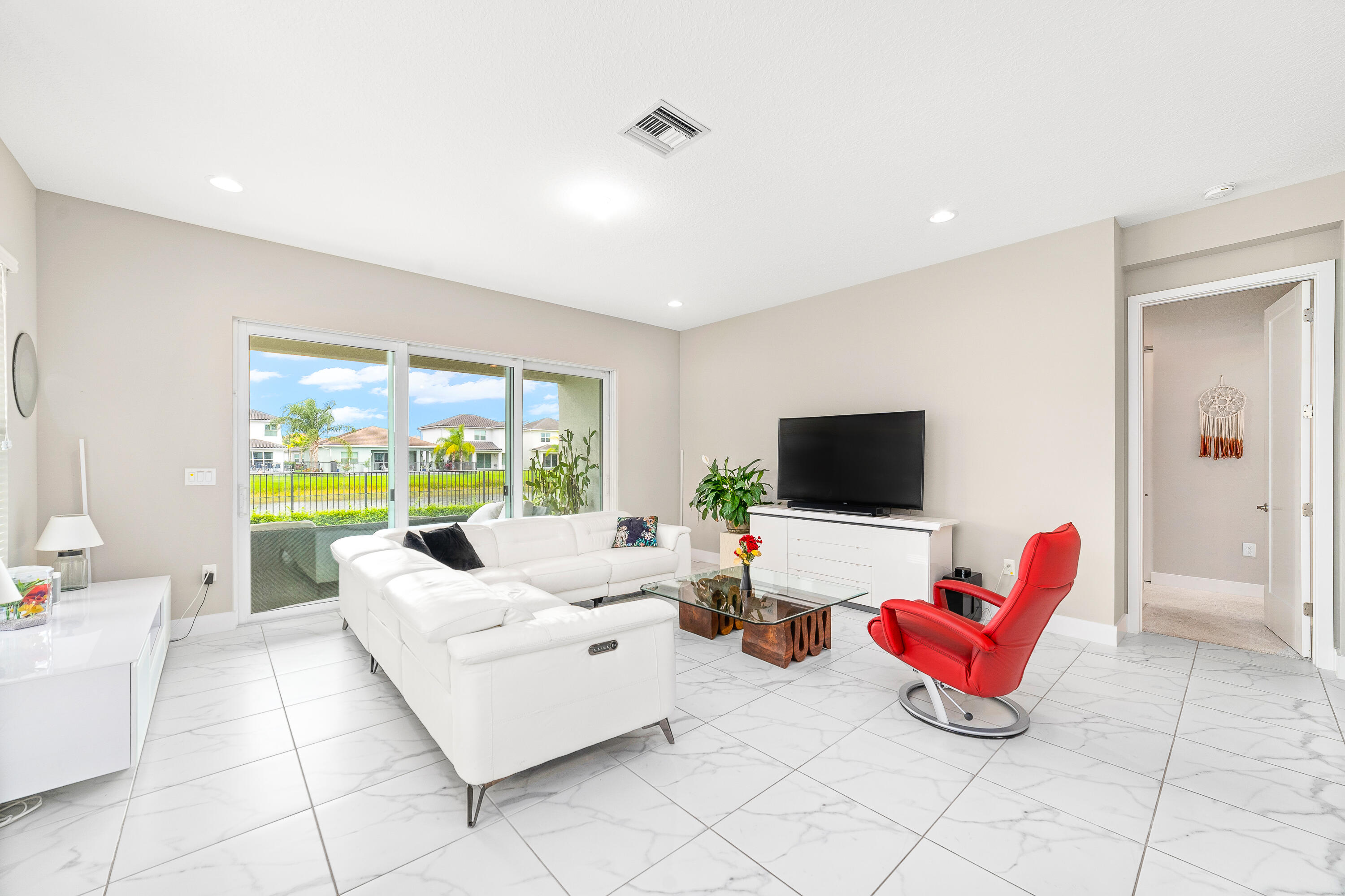 15380 Blue River Road Delray Beach, FL 33446 - Photo 3 of 31 a living room with furniture and floor to ceiling window