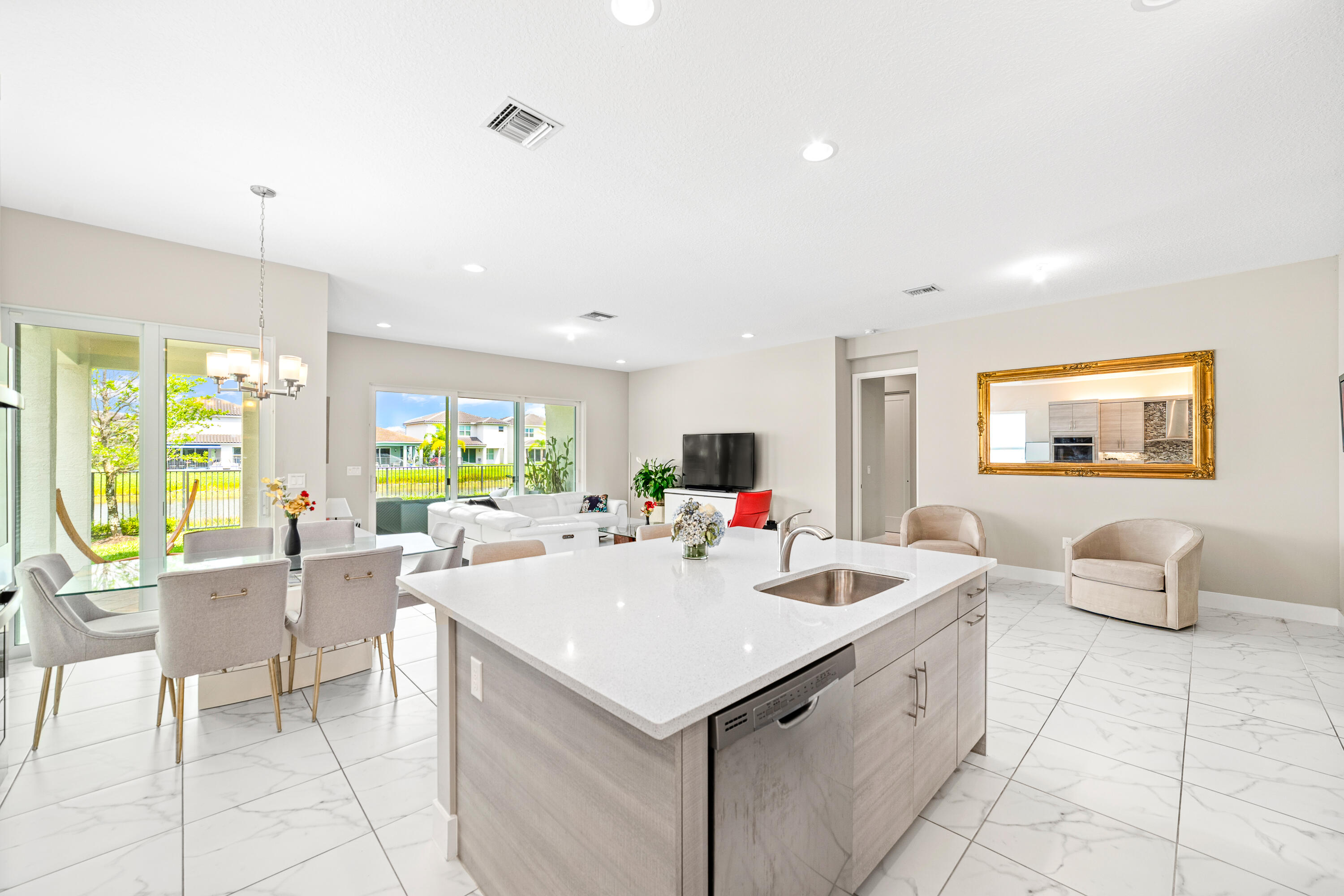 15380 Blue River Road Delray Beach, FL 33446 - Photo 7 of 31 a view of a kitchen with kitchen island stainless steel appliances a table and chairs in it