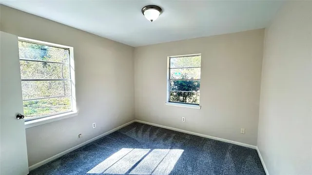 a room with a washing machine and cabinets