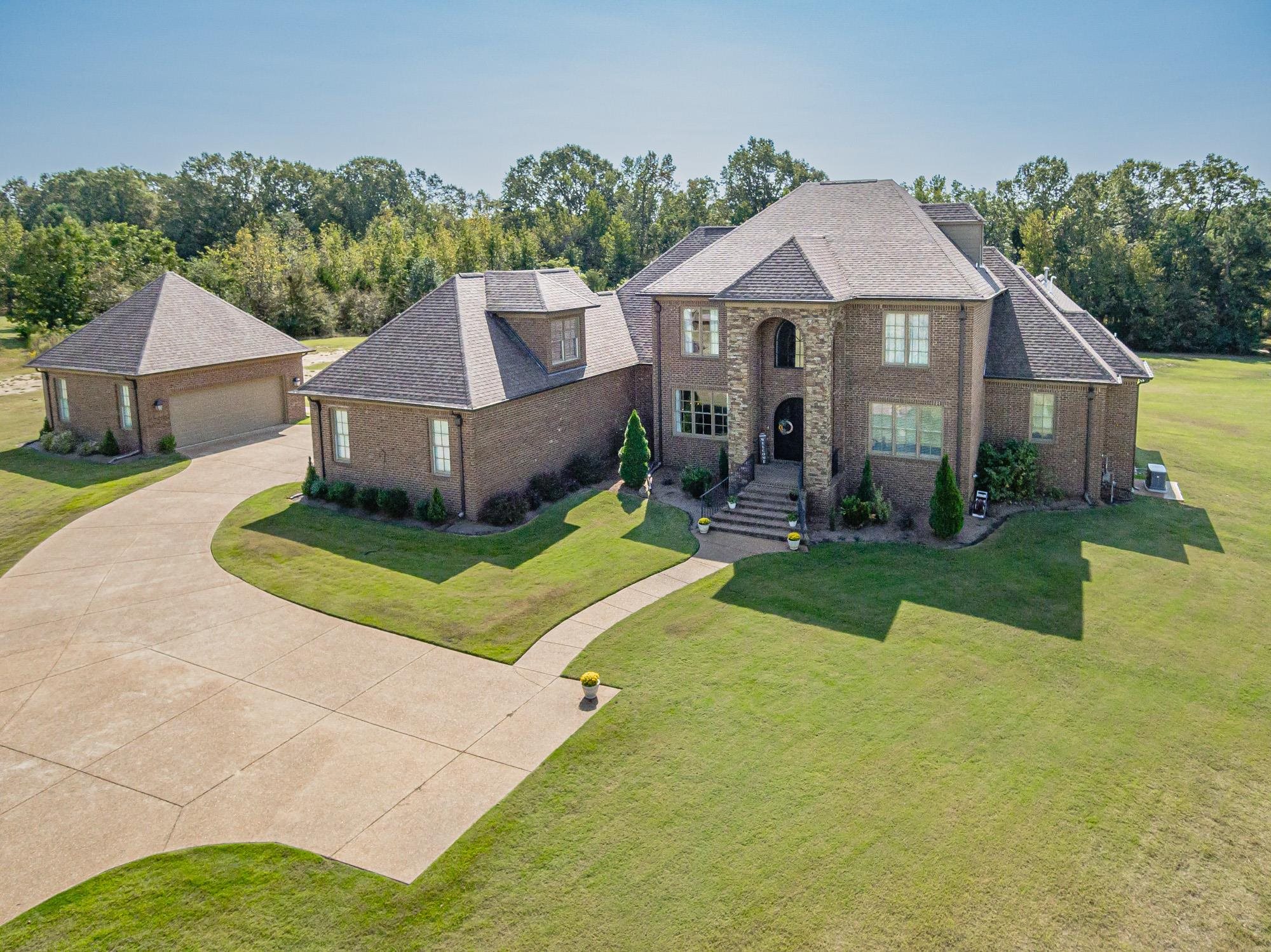 a front view of a house with a yard table and chairs