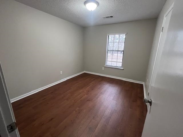 2541 Ray Bluff Road Millington, TN 38053 - Photo 8 of 12 Empty room featuring a textured ceiling and dark wood finished floors