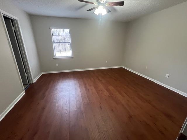 2541 Ray Bluff Road Millington, TN 38053 - Photo 9 of 12 Unfurnished bedroom featuring a textured ceiling, a ceiling fan, and dark wood-style floors