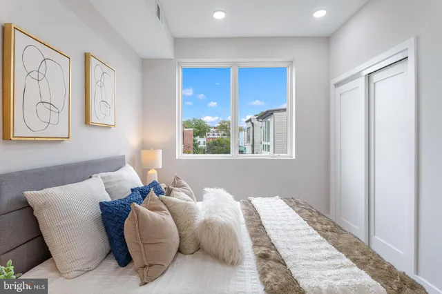 a bed room with a bed and a window