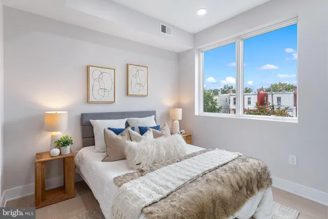 a bedroom with a bed and a window