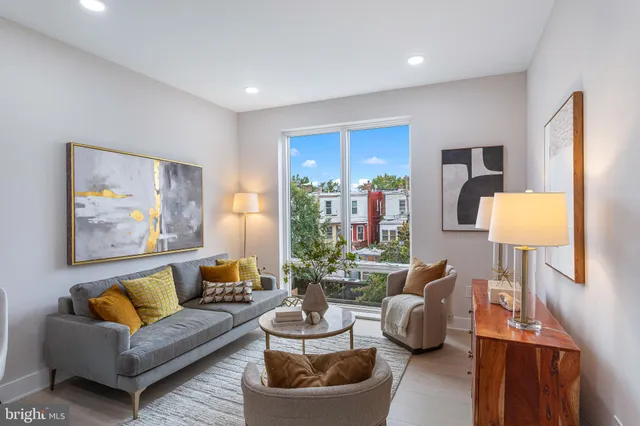 a living room with furniture and a lamp
