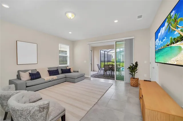 a bedroom with furniture and a large window