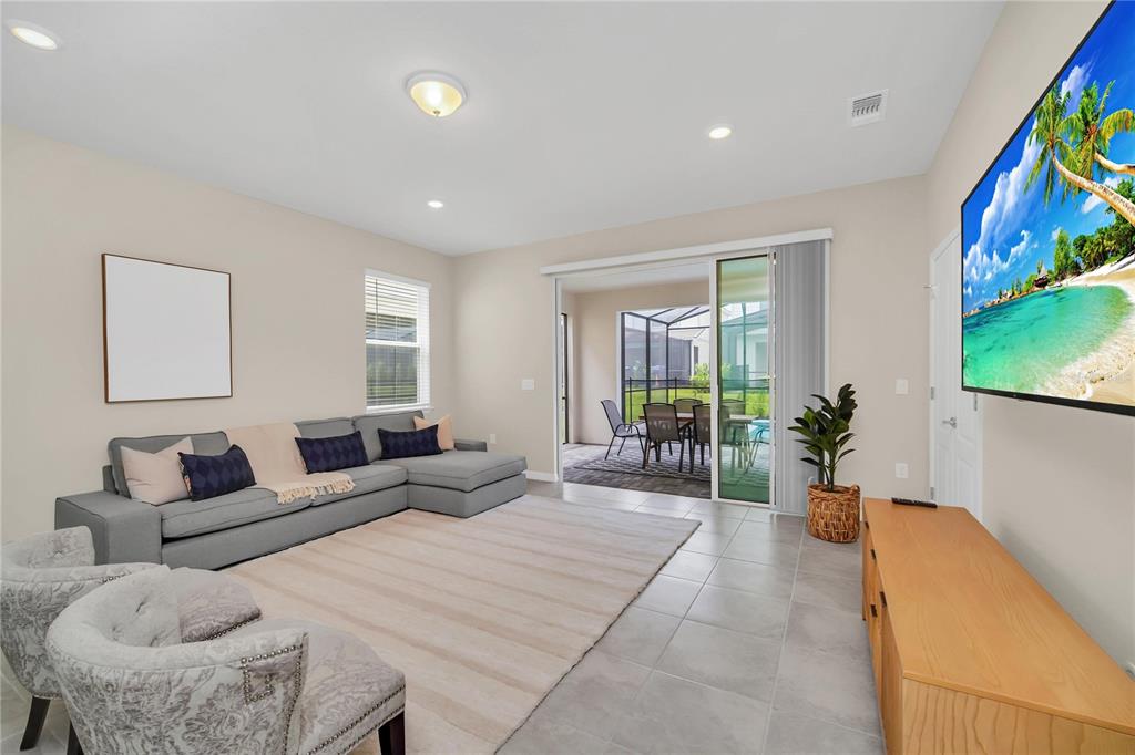 7196 Oakmoss Loop Davenport, FL 33837 - Photo 16 of 48 a bedroom with furniture and a large window