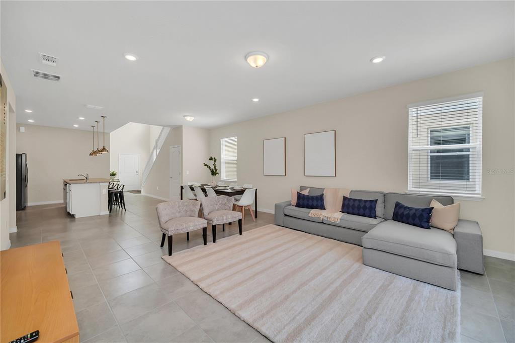 7196 Oakmoss Loop Davenport, FL 33837 - Photo 17 of 48 a living room with furniture and a large window