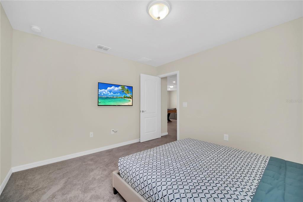 7196 Oakmoss Loop Davenport, FL 33837 - Photo 19 of 48 a view of a room with a flat screen tv