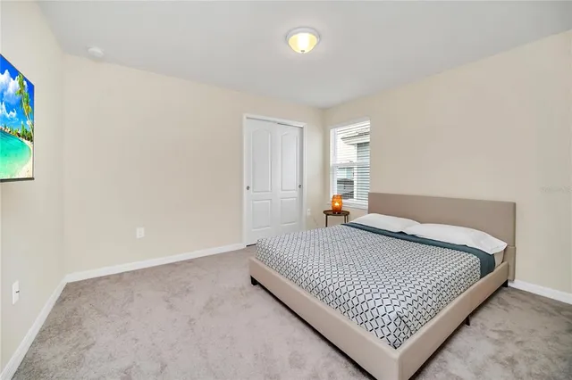 a bedroom with a bed and window