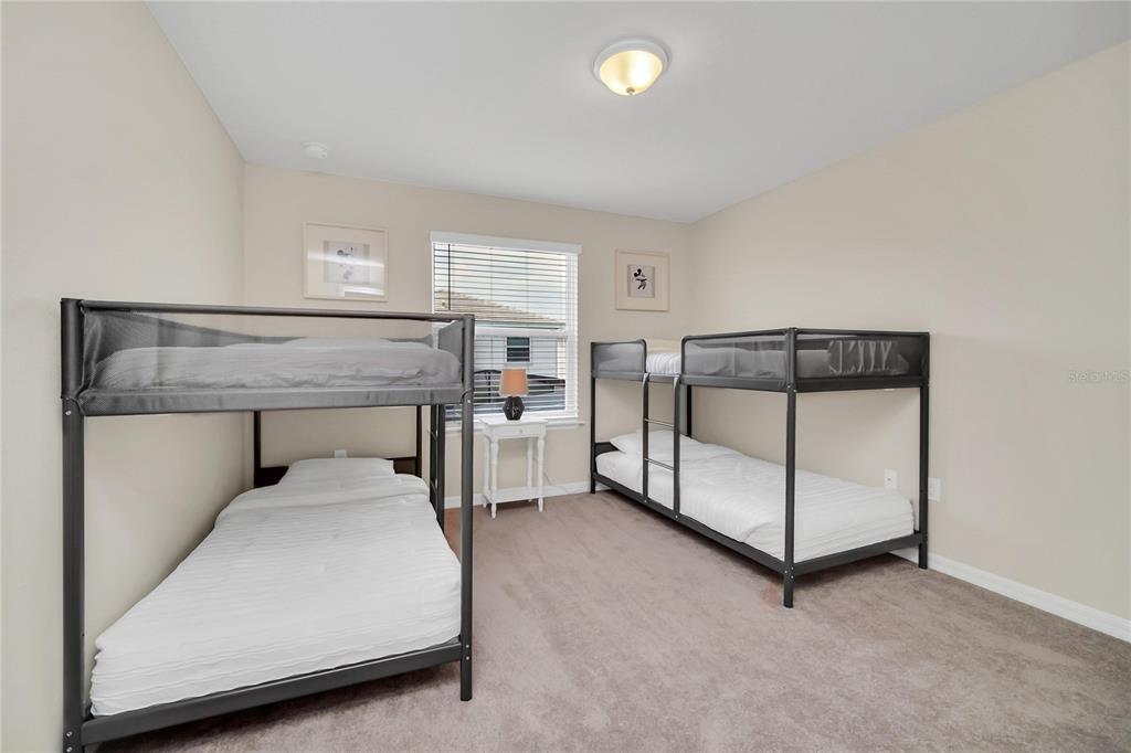 7196 Oakmoss Loop Davenport, FL 33837 - Photo 28 of 48 a bedroom with a bed and a window