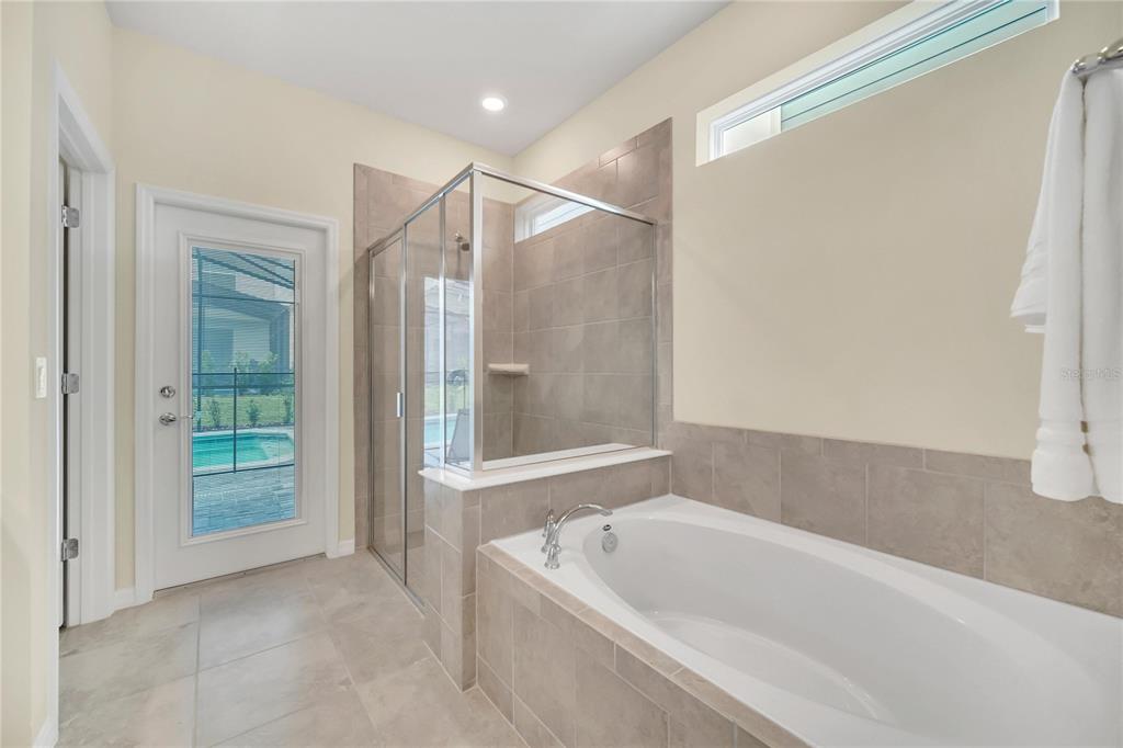 7196 Oakmoss Loop Davenport, FL 33837 - Photo 3 of 48 a bathroom with a tub shower and sink