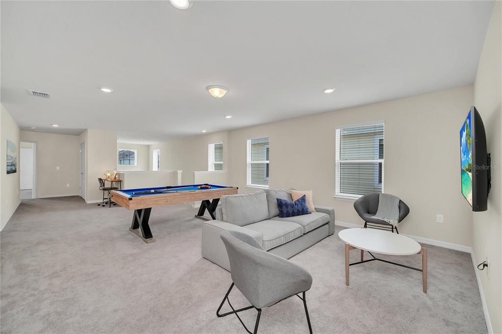 7196 Oakmoss Loop Davenport, FL 33837 - Photo 35 of 48 a living room with furniture and a wooden floor