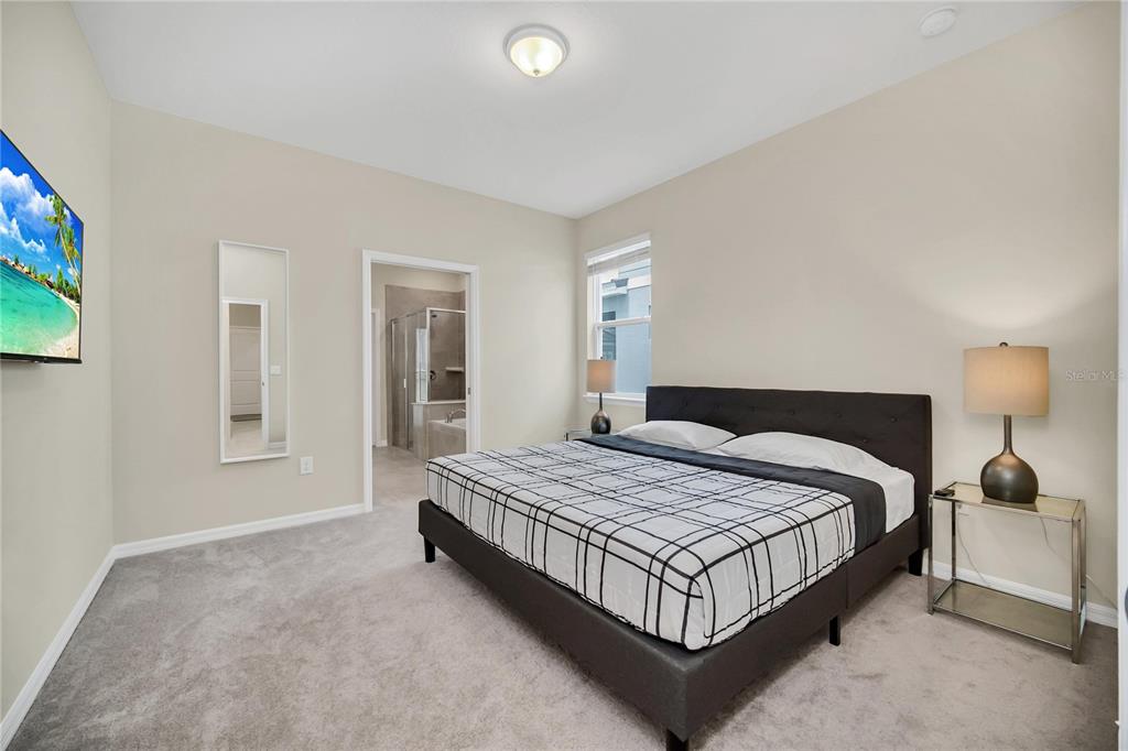 7196 Oakmoss Loop Davenport, FL 33837 - Photo 38 of 48 a bedroom with a bed lamp closet and window